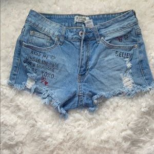 jean shorts with writing.